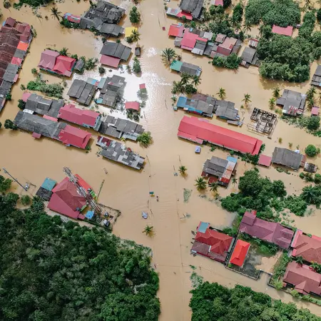 Aerial view of residential properties surrounded by standing water